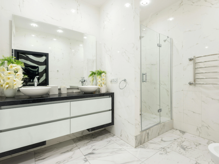Luxury bathroom with white marble tile flooring and walls