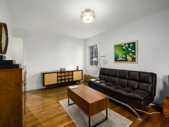 Rustic LVP Floors in a small living room with white walls