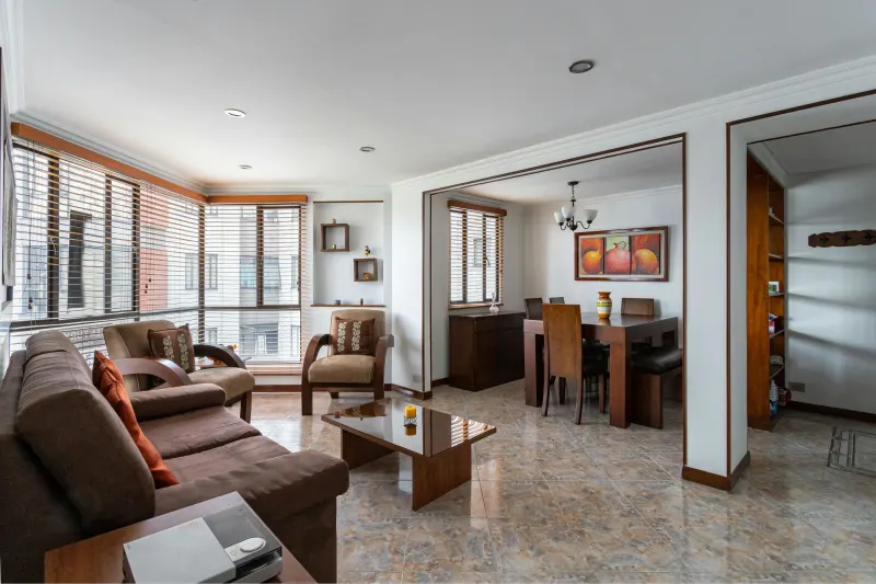 Earthy marbled tile floor in a compact open concept apartment