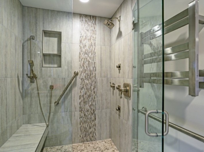 Accessible shower with patterned tiles, seat and safety bars