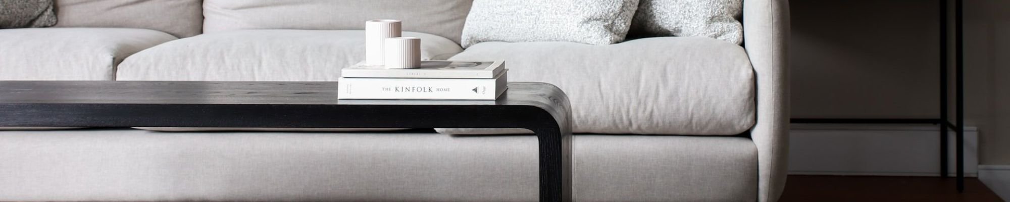 white couch and black coffee table on a brown hardwood floor from Cost + 20% in the Glendale, AZ area