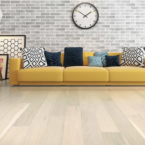 Yellow sofa in a bright living room with hardwood floors