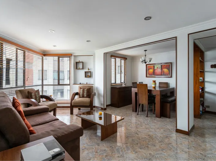 Earthy marbled tile floor in a compact open concept apartment